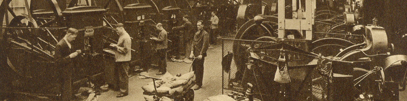 Old black and white photo of coining machines in a Victorian factory